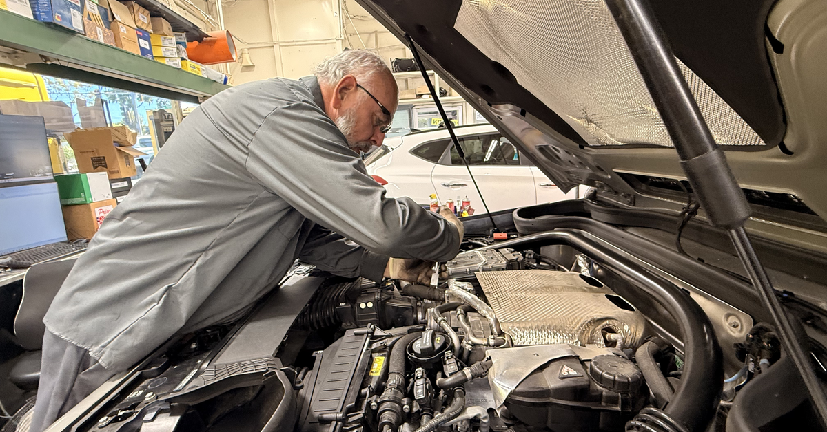 Hillside technician working at an engine bay
