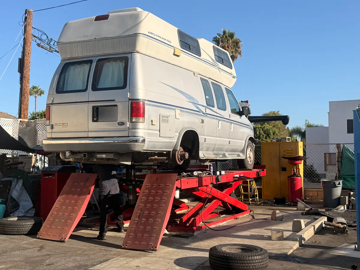 Camper van on a lift at Hillside with a rear wheel removed